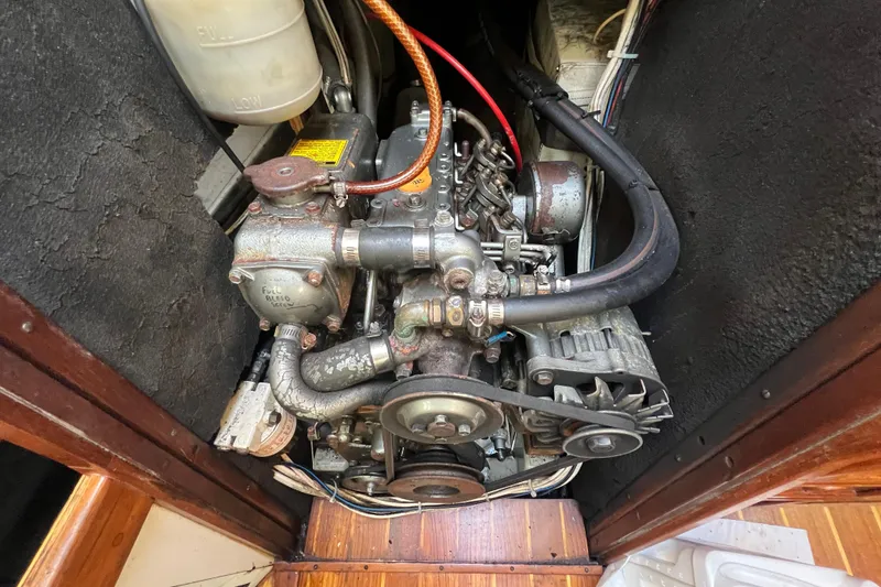 Slide: The Image of Engine compartment of a 1986 Victoria 34 Sloop, showcasing mechanical components and wiring. - 29