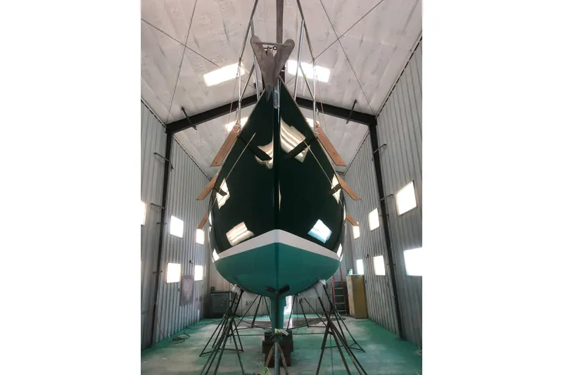 Slide: The Image of 1986 Victoria 34 Sloop in a boatyard, suspended for maintenance. - 31