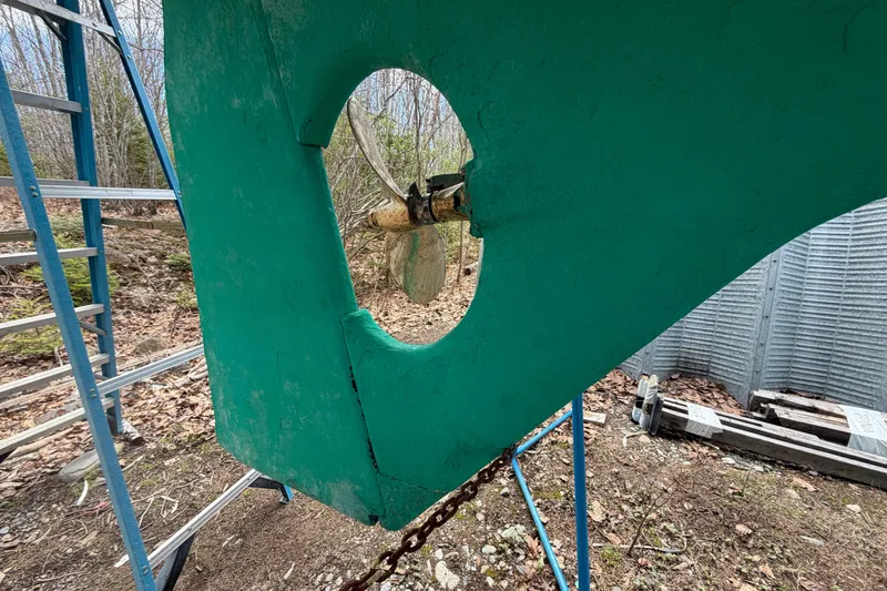 Slide: The Image of Close-up of a 1986 Victoria 34 Sloop's propeller and rudder, with a ladder nearby. - 48