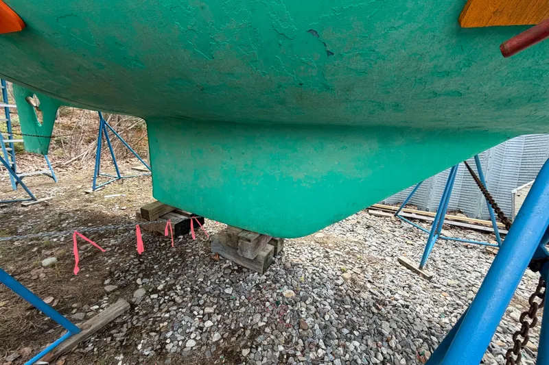 Slide: The Image of 1986 Victoria 34 Sloop keel on dry dock, supported by stands and blocks. - 49