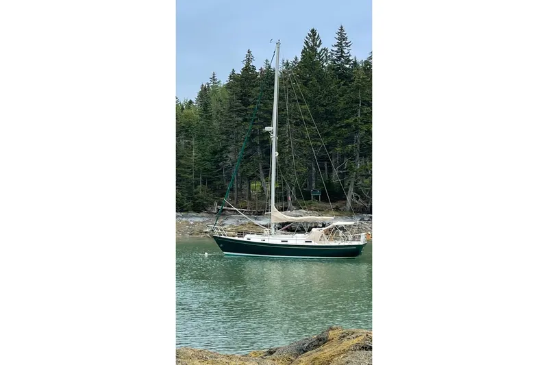 Slide: The Image of Sailboat on calm water, 1986 Victoria 34 Sloop, forested shoreline background. - 50