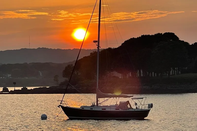 Slide: The Image of Sailboat Victoria 34 Sloop, 1986, at sunset on tranquil water. - 51