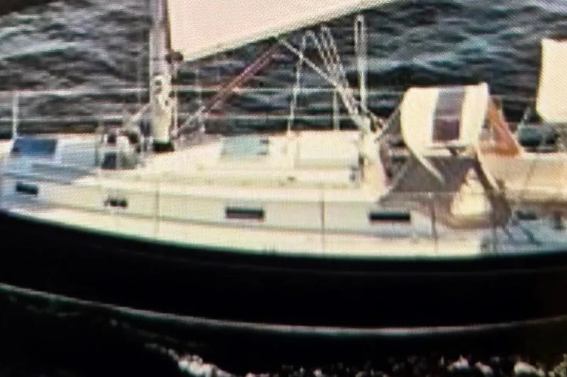 Slide: The Image of 1986 Victoria 34 Sloop sailing on open water, side view. - 52