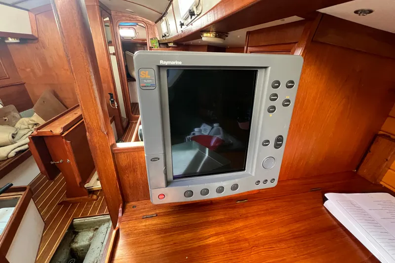 Slide: The Image of Raymarine chartplotter on 1986 Victoria 34 Sloop's wooden interior. - 6