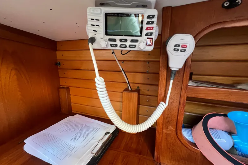 Slide: The Image of Radio equipment inside a 1986 Victoria 34 Sloop, featuring wooden interior details. - 7