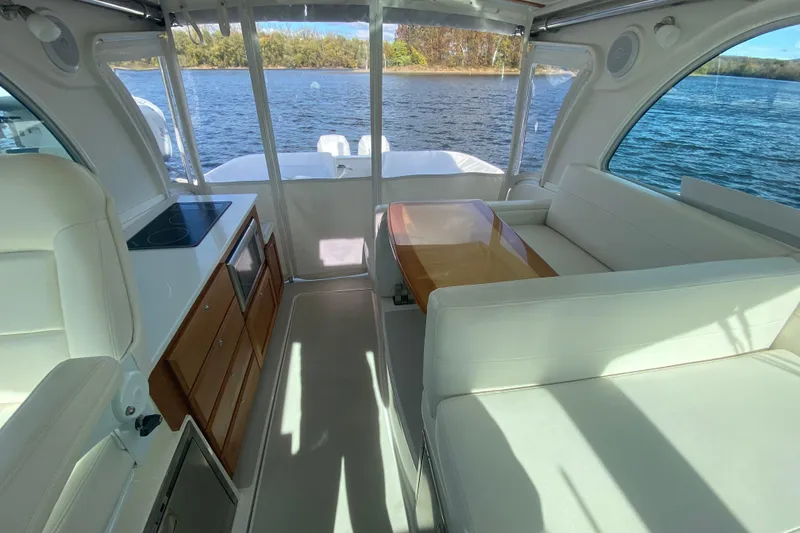 Slide: The Image of 2022 Back Cove 34O boat docked on a sunny day with blue sky and clouds. - 10