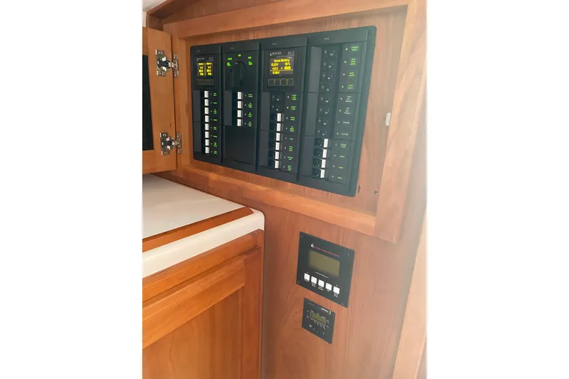 Slide: The Image of 2022 Back Cove 34O boat docked, featuring covered seating and a small table. - 11