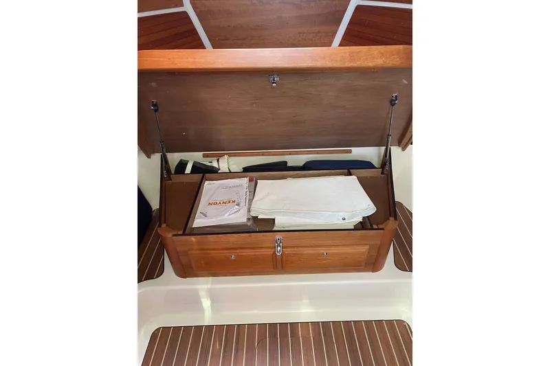 Slide: The Image of 2022 Back Cove 34O yacht interior with elegant seating and wooden table by the water. - 13