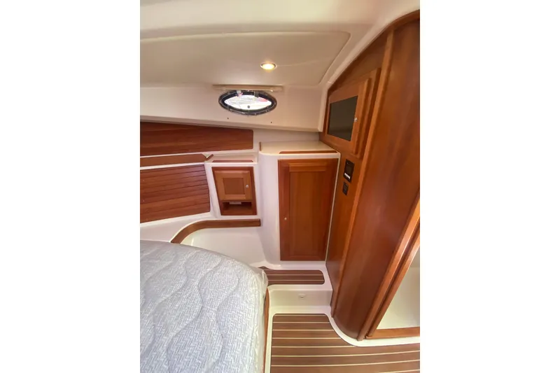 Slide: The Image of 2022 Back Cove 34O yacht interior with kitchenette, featuring stove, microwave, and sink. - 14