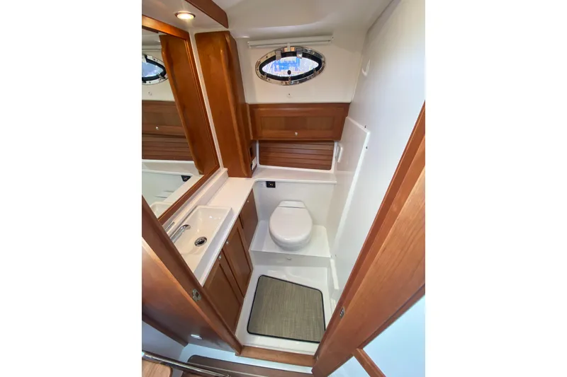 Slide: The Image of Helm station of 2022 Back Cove 34O boat with modern controls and white seating. - 16