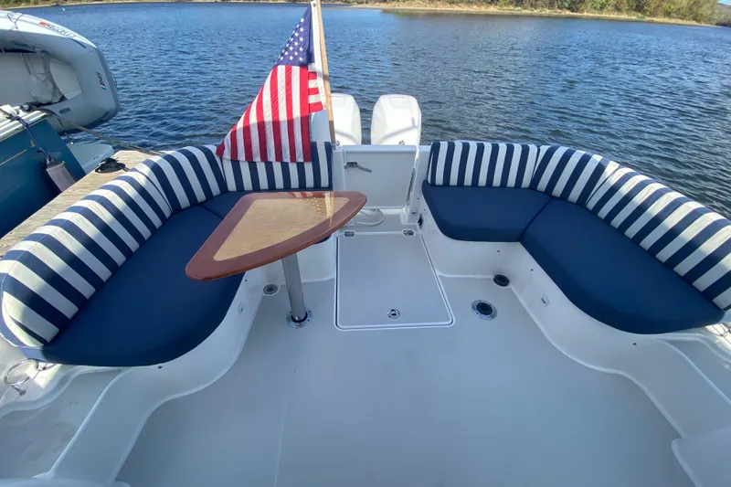 Slide: The Image of Interior of 2022 Back Cove 34O yacht with seating, table, and water view. - 18
