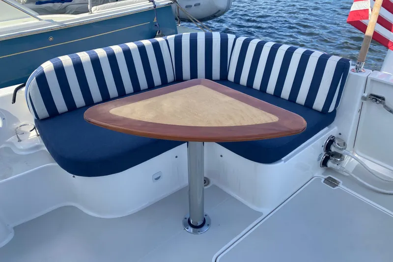 Slide: The Image of Interior of 2022 Back Cove 34O yacht with seating and kitchenette, overlooking water. - 19