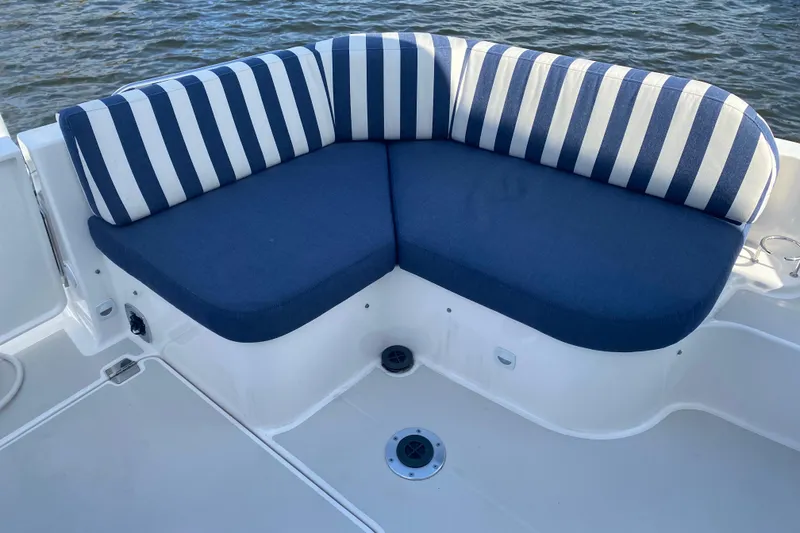 Slide: The Image of Blue and white striped seating on 2022 Back Cove 34O boat, overlooking water. - 29