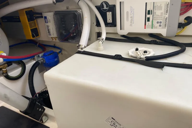 Slide: The Image of Engine compartment of 2022 Back Cove 34O with electrical and plumbing components. - 33