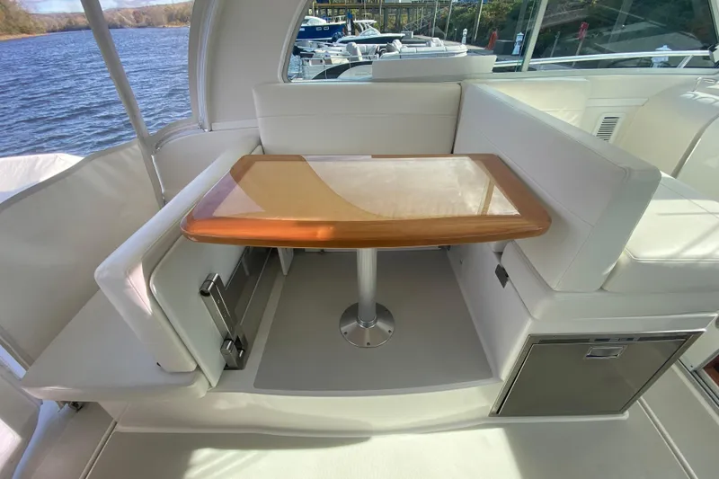 Slide: The Image of 2022 Back Cove 34O boat cruising on a lake with trees in the background. - 4