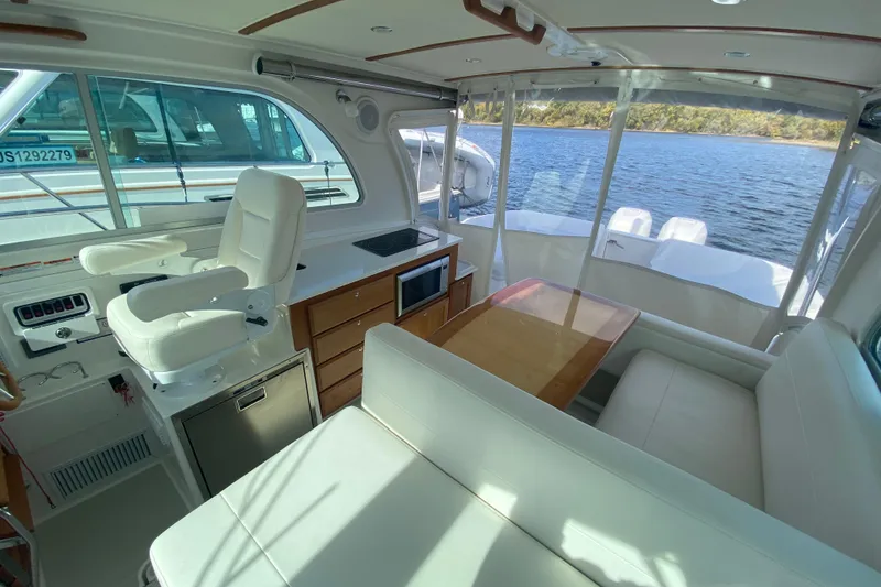 Slide: The Image of 2022 Back Cove 34O boat docked on a sunny day, featuring sleek design and modern amenities. - 9