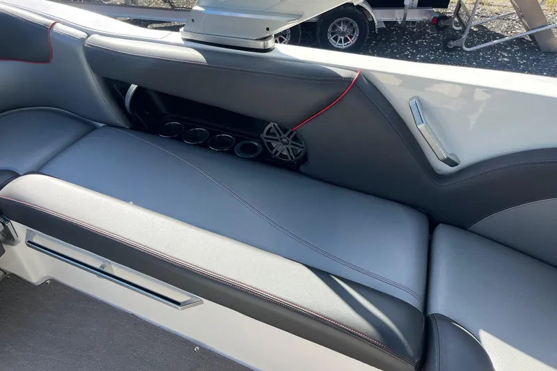 Slide: The Image of 2017 MasterCraft X23 interior seating with cup holders and speaker. - 11