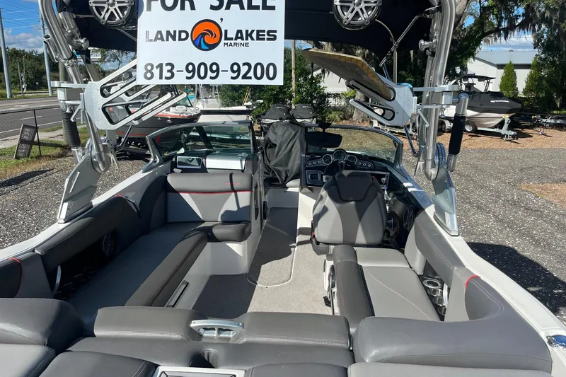 Slide: The Image of 2017 MasterCraft X23 boat interior with seating, for sale sign, and contact number. - 13