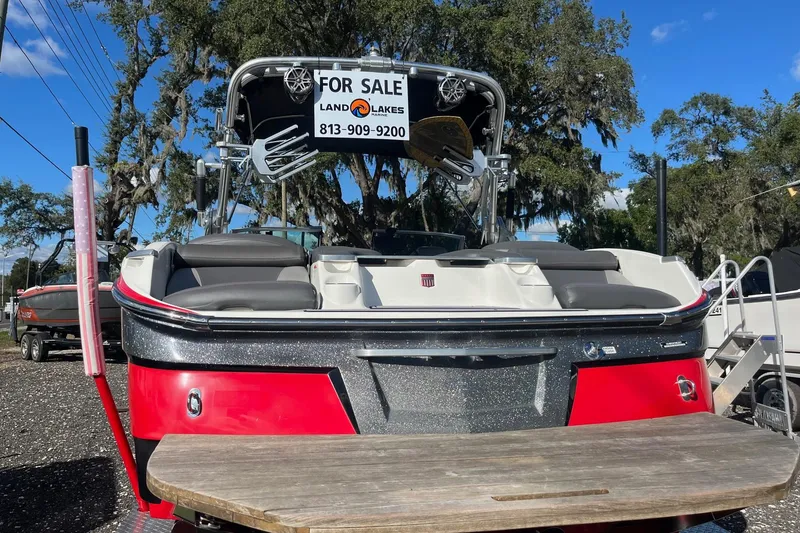 Slide: The Image of 2017 MasterCraft X23 boat for sale, red and silver, with seating and wakeboard tower. - 15