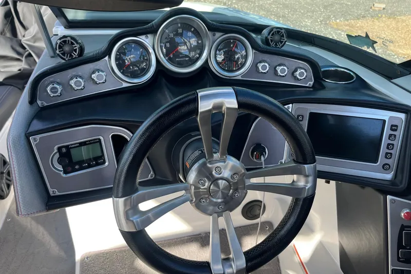 Slide: The Image of 2017 MasterCraft X23 dashboard with steering wheel, gauges, and control panel. - 4