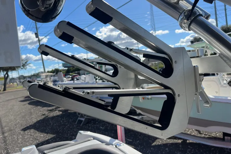 Slide: The Image of 2017 MasterCraft X23 boat with a sleek, metallic wakeboard rack under a clear blue sky. - 6