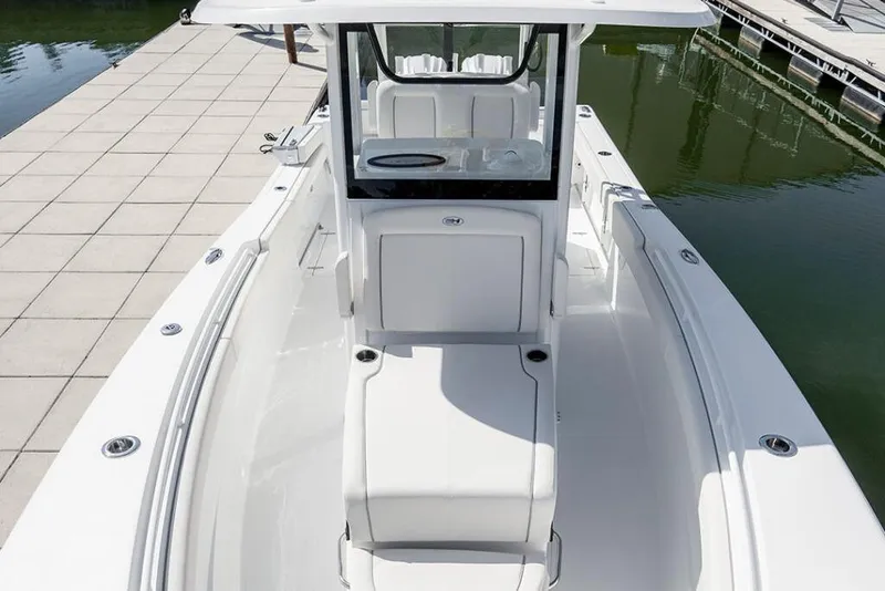 Slide: The Image of 2026 Sea Hunt Gamefish 28 Coffin Box boat docked, showcasing sleek design and spacious deck. - 12