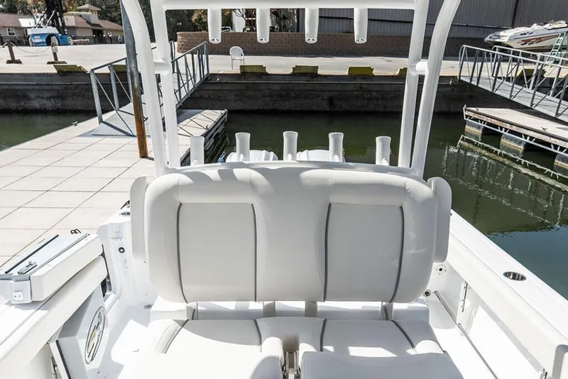 Slide: The Image of 2026 Sea Hunt Gamefish 28 Coffin Box boat interior with white seating at dock. - 13
