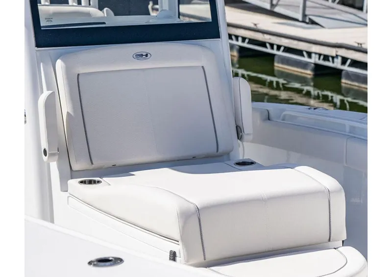 Slide: The Image of Manufacturer Provided Image: 2026 Sea Hunt Gamefish 28 Coffin Box boat seat, white upholstery, docked at marina. - 4