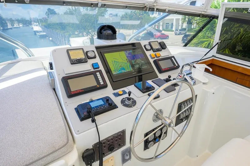 Slide: The Image of Cockpit of 1998 Hatteras 70 Cockpit Motor Yacht with navigation equipment and steering wheel. - 24