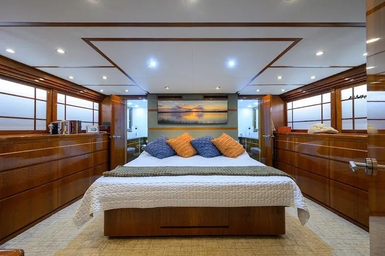 Slide: The Image of Luxurious bedroom interior of 1998 Hatteras 70 Cockpit Motor Yacht with elegant wood finishes. - 29