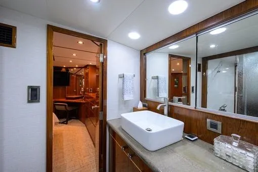 Slide: The Image of Luxurious bathroom in 1998 Hatteras 70 Cockpit Motor Yacht with modern fixtures and wood accents. - 32