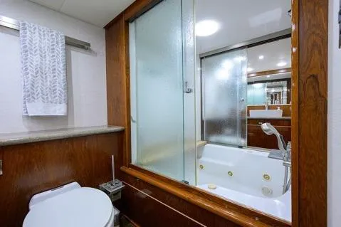 Slide: The Image of Bathroom interior of 1998 Hatteras 70 Cockpit Motor Yacht with shower and wooden accents. - 33