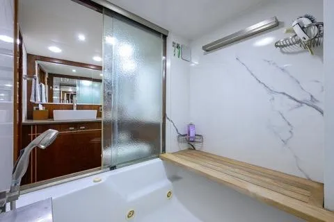 Slide: The Image of Luxurious bathroom in 1998 Hatteras 70 Cockpit Motor Yacht with modern fixtures. - 34