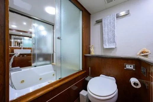 Slide: The Image of Luxurious bathroom in 1998 Hatteras 70 Cockpit Motor Yacht with jacuzzi and modern fixtures. - 35