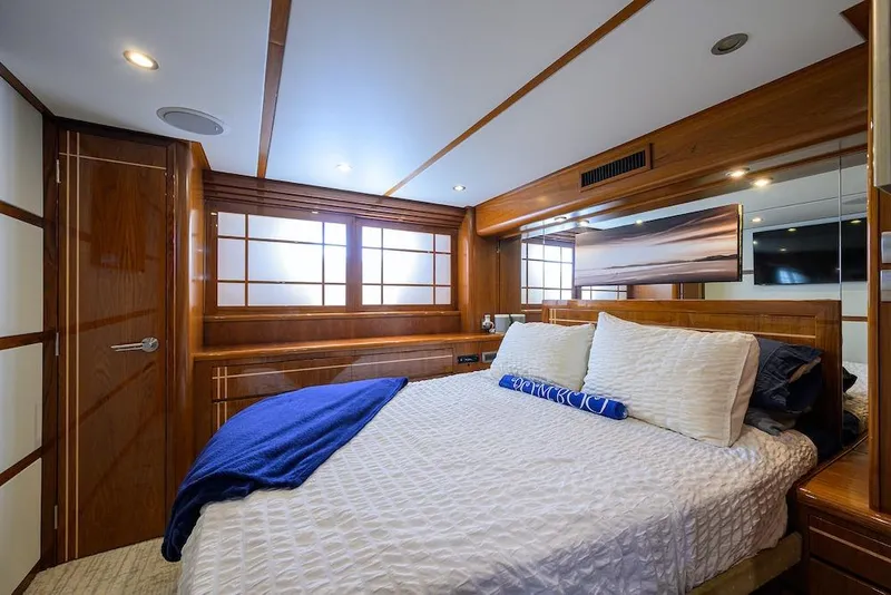 Slide: The Image of Luxurious bedroom interior of 1998 Hatteras 70 Cockpit Motor Yacht with wood accents. - 36