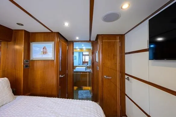 Slide: The Image of Luxurious cabin interior of 1998 Hatteras 70 Cockpit Motor Yacht with wood paneling. - 37