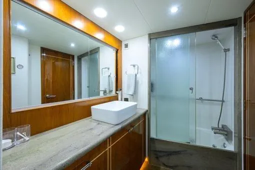 Slide: The Image of Luxurious bathroom in 1998 Hatteras 70 Cockpit Motor Yacht with modern fixtures. - 38