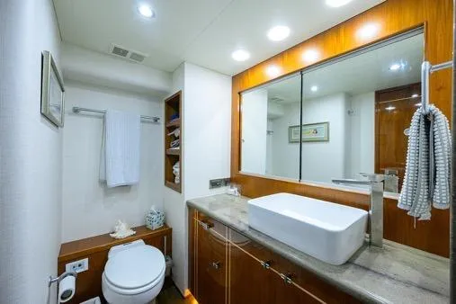 Slide: The Image of Luxurious bathroom in 1998 Hatteras 70 Cockpit Motor Yacht with modern fixtures and elegant design. - 39
