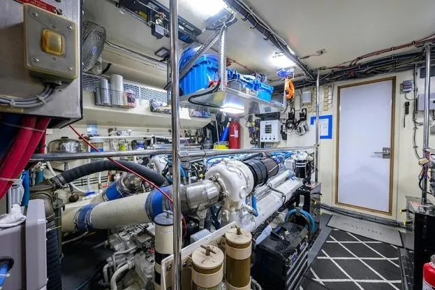 Slide: The Image of Engine room of 1998 Hatteras 70 Cockpit Motor Yacht, showcasing machinery and equipment. - 46