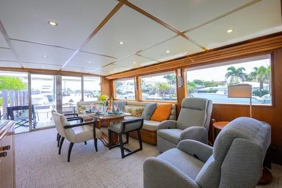 Slide: The Image of Luxurious interior of 1998 Hatteras 70 Cockpit Motor Yacht with elegant seating and dining area. - 5
