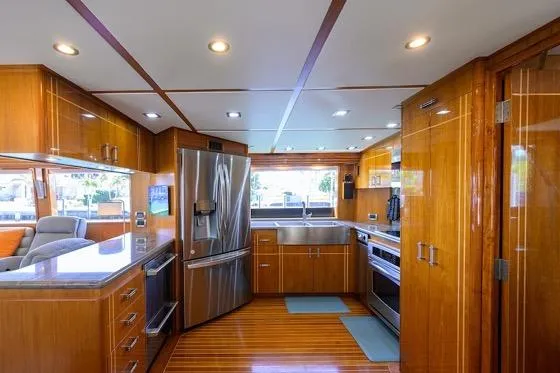 Slide: The Image of Luxurious kitchen interior of 1998 Hatteras 70 Cockpit Motor Yacht with modern appliances. - 8