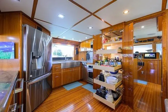 Slide: The Image of Luxurious kitchen interior of 1998 Hatteras 70 Cockpit Motor Yacht with modern appliances. - 9
