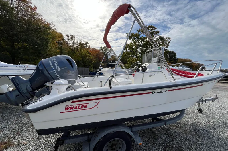 Slide: The Image of 2001 Boston Whaler 16 Dauntless boat with Yamaha engine on a trailer, outdoors. - 10