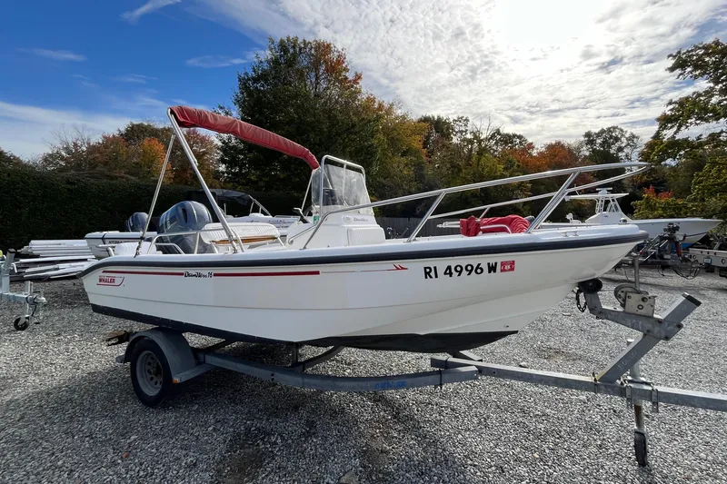 Slide: The Image of 2001 Boston Whaler 16 Dauntless boat on trailer, parked outdoors. - 11
