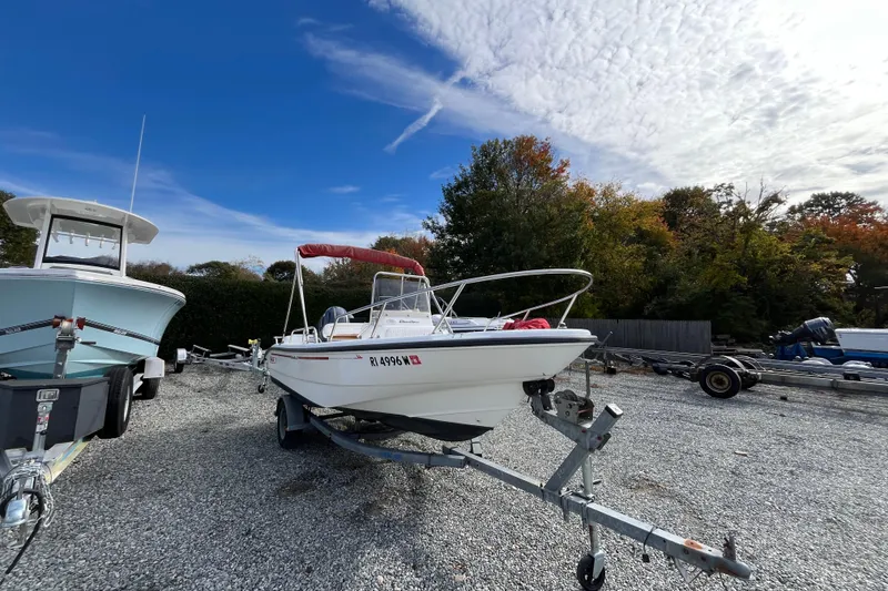 Slide: The Image of 2001 Boston Whaler 16 Dauntless boat on trailer, parked outdoors under a blue sky. - 12