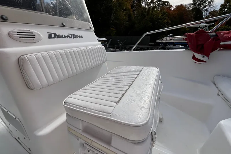 Slide: The Image of 2001 Boston Whaler 16 Dauntless boat interior with white cushioned seating. - 14