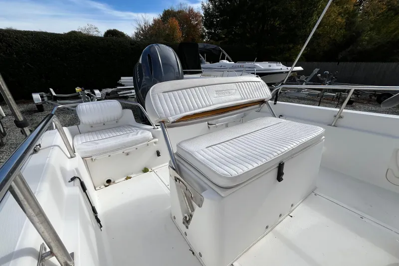 Slide: The Image of 2001 Boston Whaler 16 Dauntless boat interior with white seating and stainless steel railings. - 15