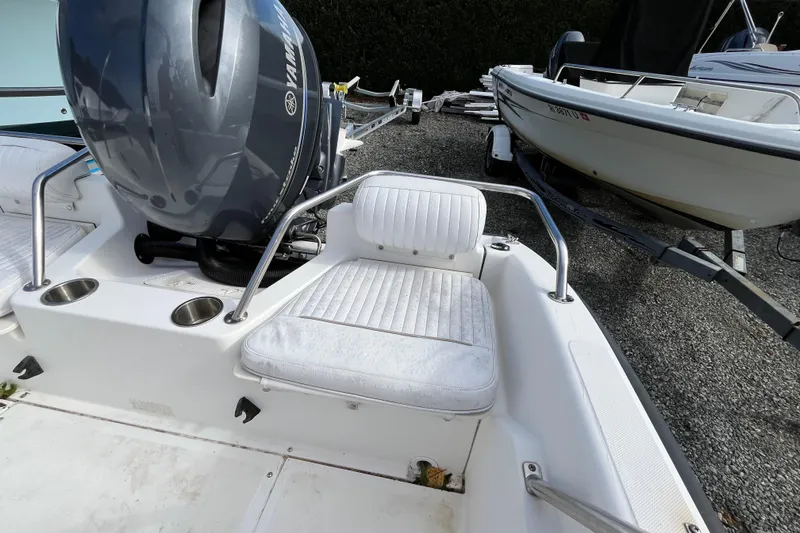 Slide: The Image of 2001 Boston Whaler 16 Dauntless boat with Yamaha engine, featuring cushioned seating. - 18