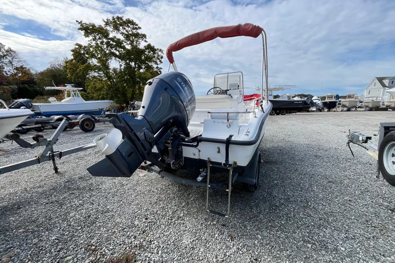 Slide: The Image of 2001 Boston Whaler 16 Dauntless boat with Yamaha outboard motor on gravel lot. - 23