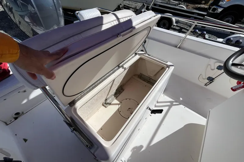 Slide: The Image of Open storage compartment on a 2001 Boston Whaler 16 Dauntless boat. - 24